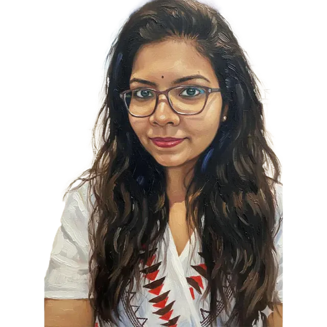 Portrait of Dt. Alekhya wearing glasses and a white embroidered blouse